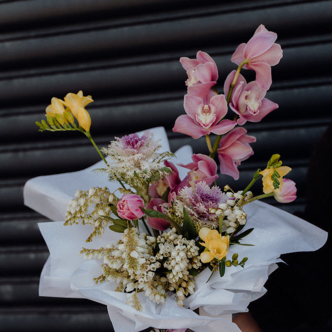 Bouquet of flowers with a card on a black background